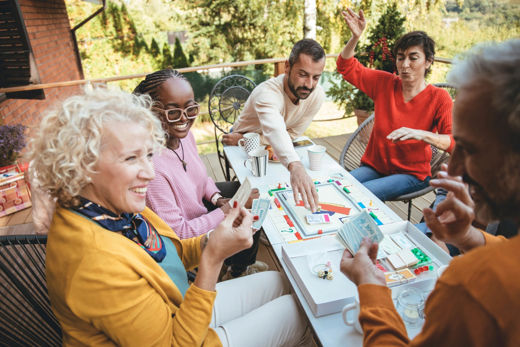 Elderly Grey hair Woman playing board game with her friends on a home porch