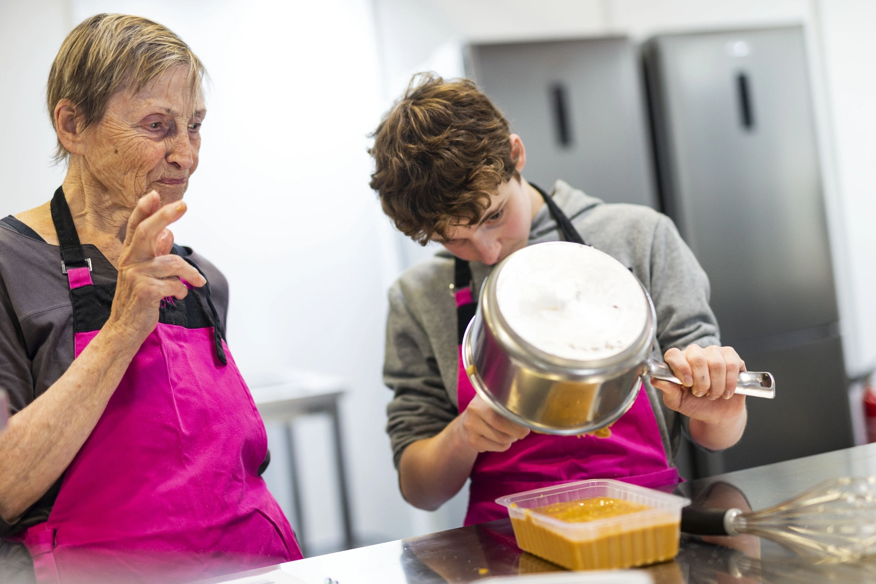 Old woman and a teenager boy dedicated to sweet delights, led by world-renowned pastry chef